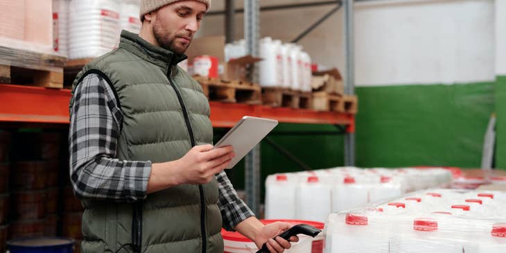 Associate Product Manager gathers product data and analyzes it on a tablet.