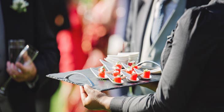 The Caterer provides food at a social gathering.