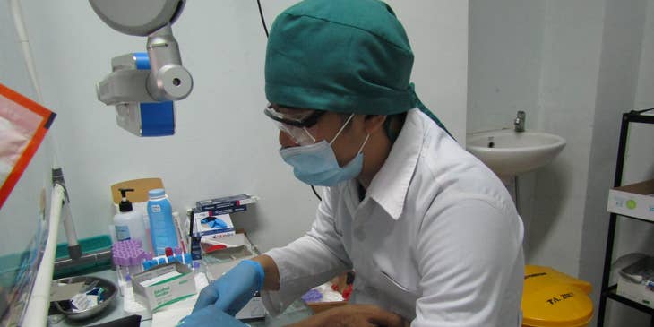 Certified Medical Assistant is taking blood from a patient for diagnosis