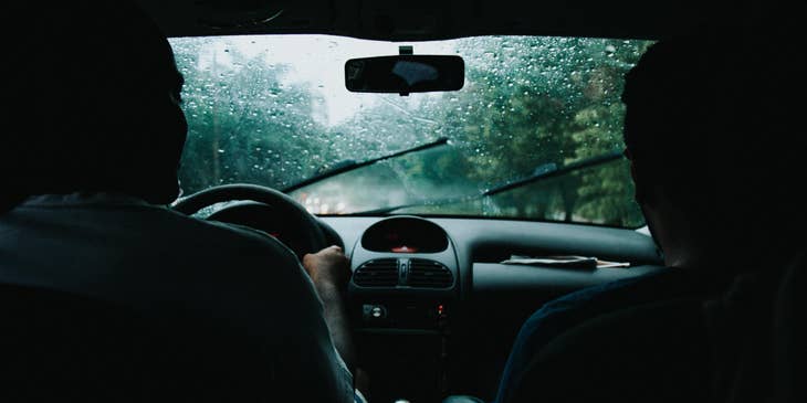 Driving Instructor teaches a new driver how to control the car safely when raining