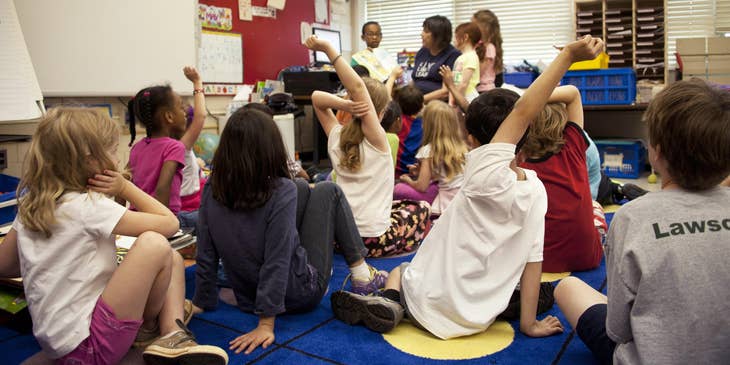 Lead preschool teacher reading stories while students were listening and asking questions