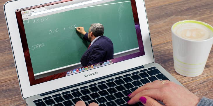 Online teacher writes a new lesson on a chalkboard