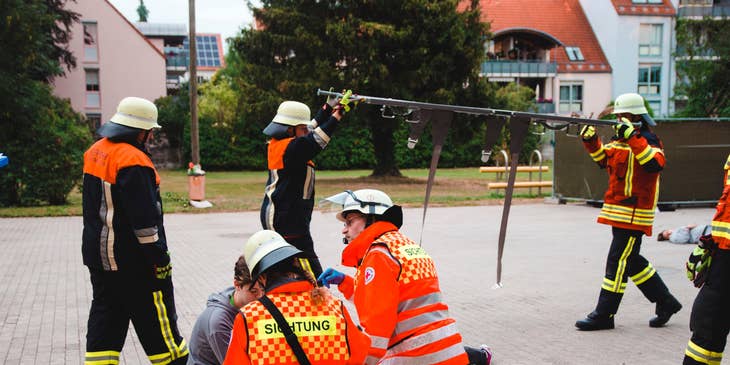 Paramedic team practice on how to use first aid as they practice safety drills outdoors