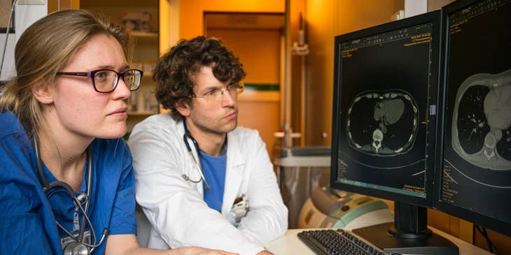 Pediatric oncologist consults with a colleague to analyze MRI results