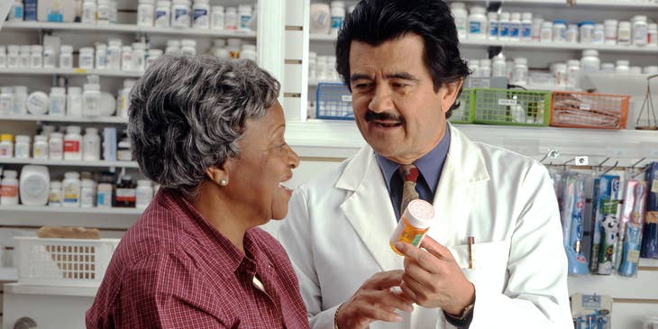 Pharmaceutical sales representative informs a client on the proper dosage and side effect of the medicine prescribed