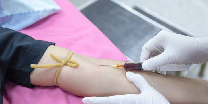 Phlebotomy technician extracts blood from the patient for blood donation