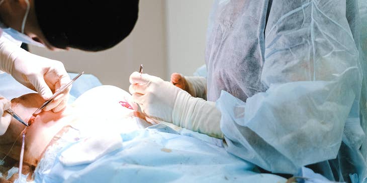 Plastic surgery nurse cleans open wound to prepare for treatment from the doctor.