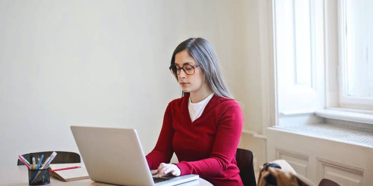 Project accountant reviews budget plan for a new client in a small office