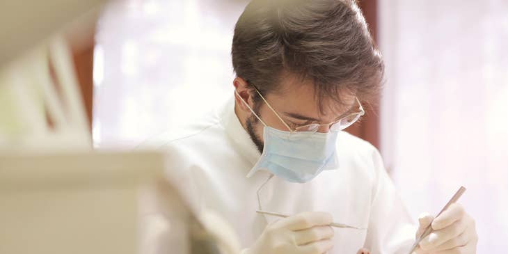 Prosthodontist performs dental implants on a patient