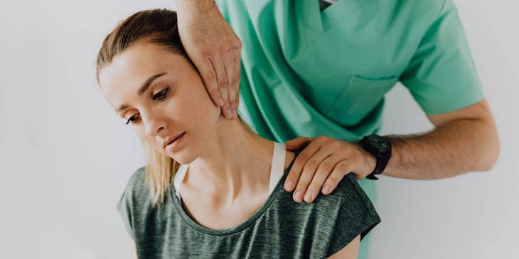 Rehab technician conducts initial screening by assessing the neck pain of the patient