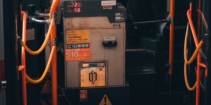 School bus driver waits for students on a bus wearing a protective mask