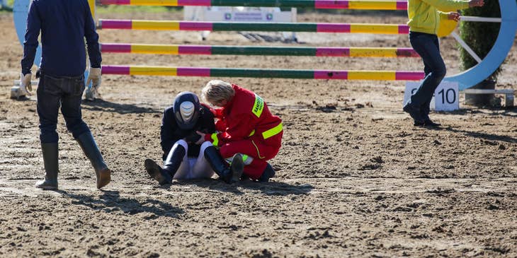 Sports medicine physician checks elbow injury of the player during an event.