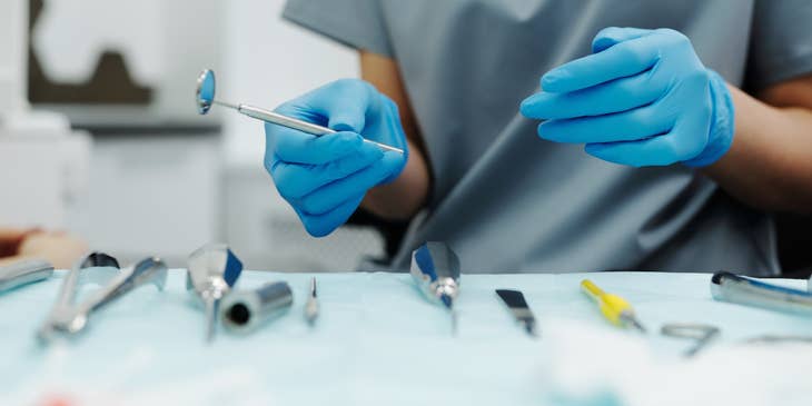 Sterile processing technician preparing surgical equipment ready for operation