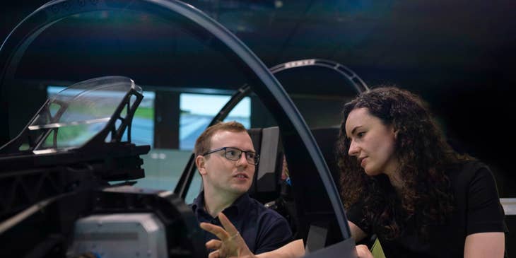 female Aerospace Engineer setting her colleague's expectations regarding the flight simulator pod