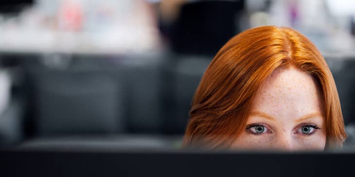 Application Support Engineer looking at her monitor to track the progress of software installation