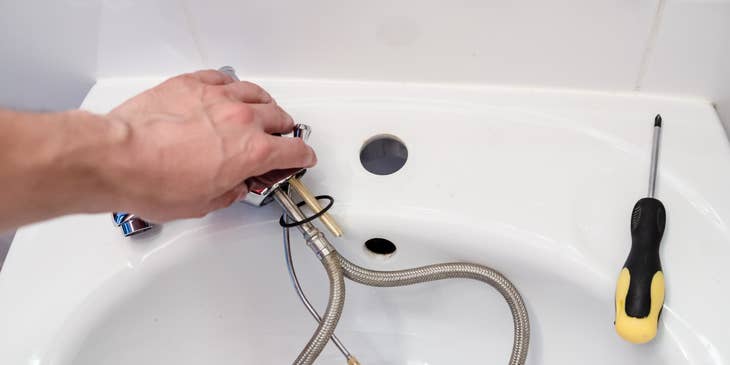 Apprentice Plumber repairing a faucet.