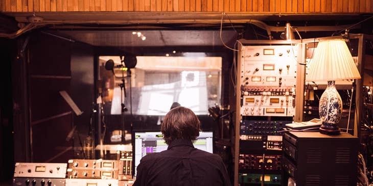 Audio Visual Technician operating the mixer for a recording session