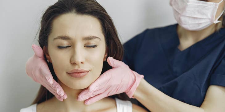 Ayurvedic Practitioner calming an anxious patient by administering a massage.