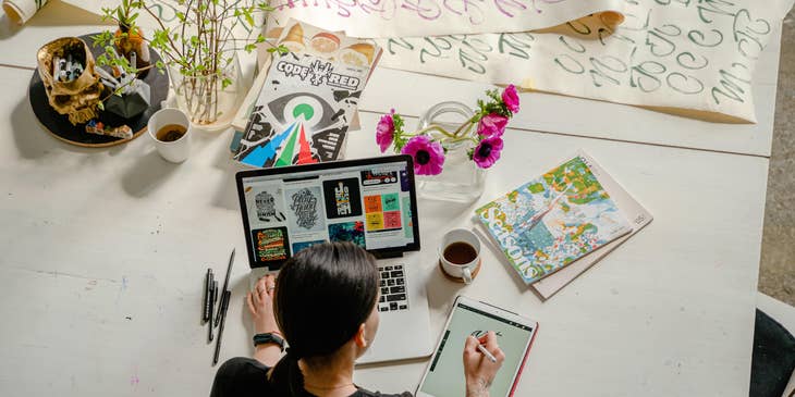 A 3D artist illustrating at a desk