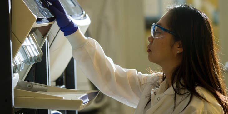 A biomedical technician preparing an experiment in a laboratory.