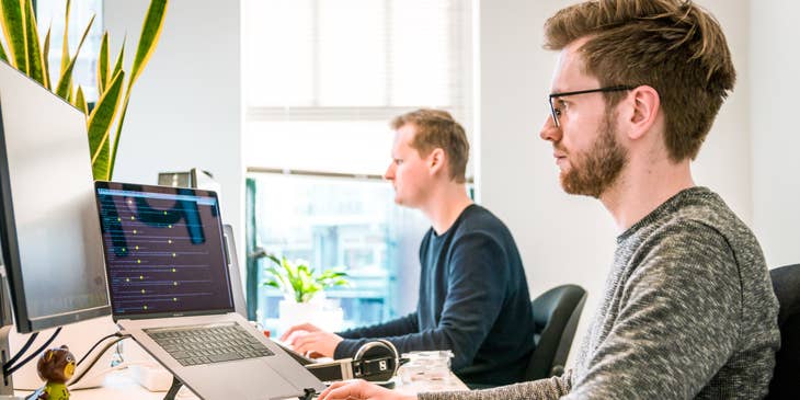 A client support specialist attending to a client query on a computer.