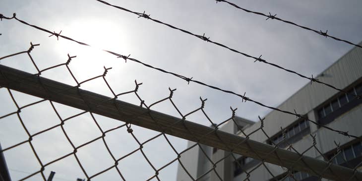 Barbed wire and fencing outside of a correctional facility.