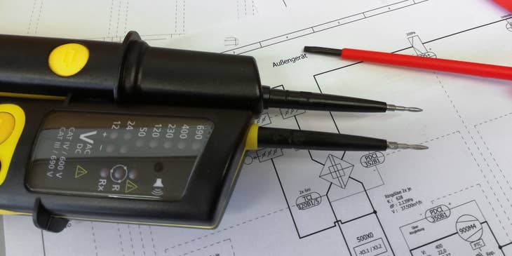 Electrical measurement tools on plans made by an electrical drafter.