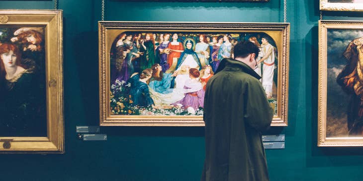 History Teacher looks at painting as he prepares a new lesson plan about art history
