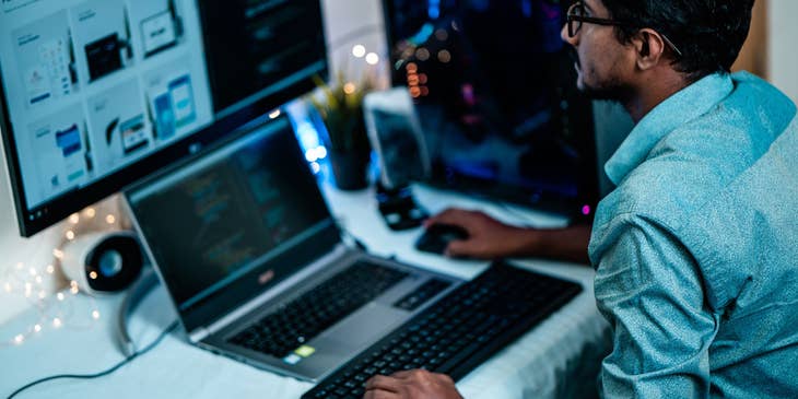 An information specialist working on a laptop with a computer screen.