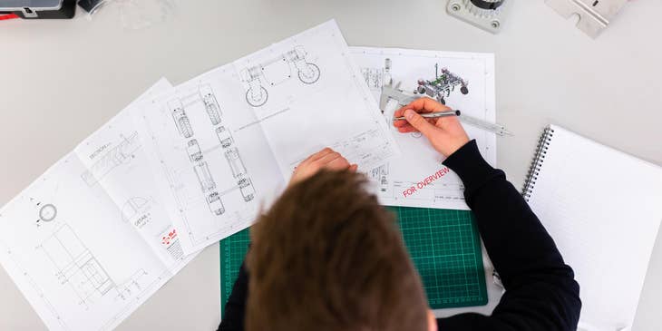 A mechanical design engineer reviewing design plans.