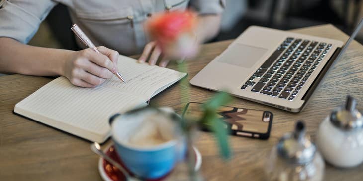 Medical copywriter making notes while researching a medical article.