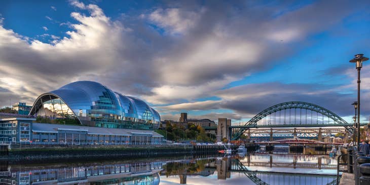 A waterside view of Sage Gateshead & Tyne Bridge in Newcastle upon Tyne.