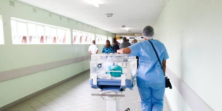 A patient transporter moving a patient in a hospital