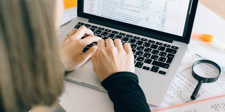 A senior auditor working on a spreadsheet.