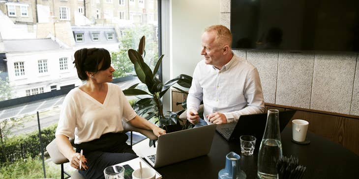 A startup consultant sitting down with an entrepreneur to discuss their business.