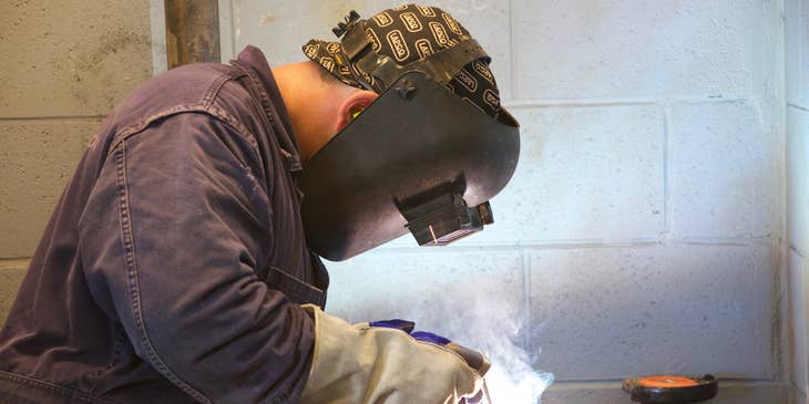 Boilermaker welding a part of the boiler