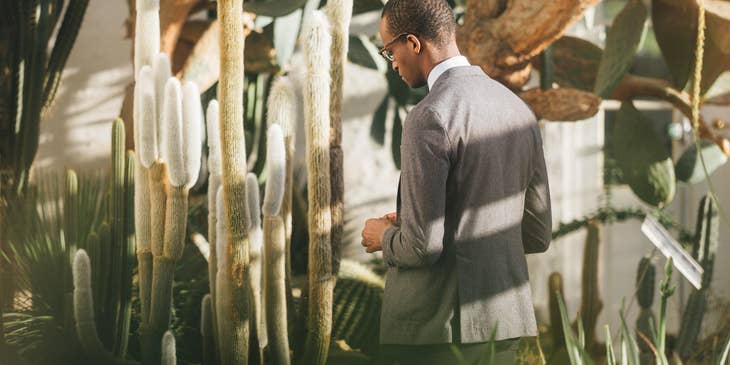 Botanist examining a cactus's' behavior to certain environment