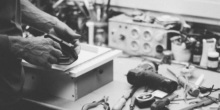 black and white photo of Cabinet Maker making a drawer as part of cabinetry