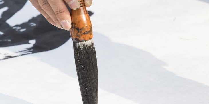 Calligrapher holding a calligraphy brush