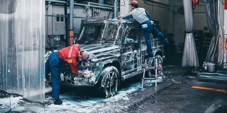 Car Detailers cleaning the exterior of a vehicle