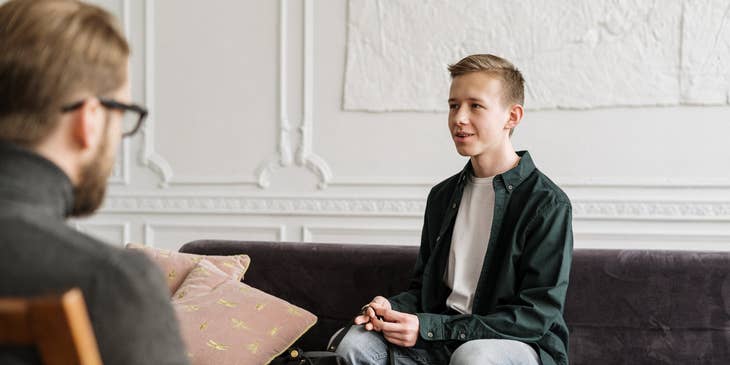 Caseworker on a counselling session with a man sitting on the couch