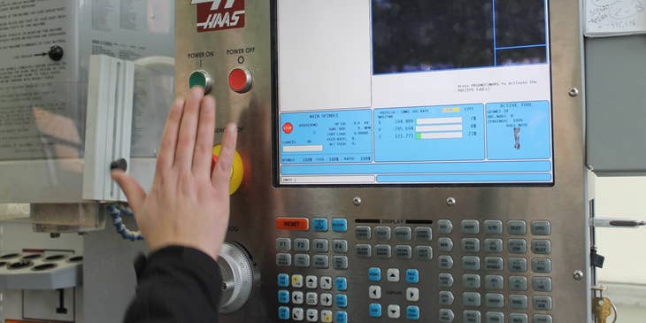 A CNC Machinist creating data instructions for a machine using a computer software.