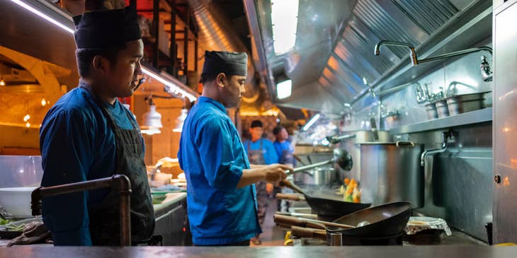 The cook is preparing food  and makes sure it is completed on time.