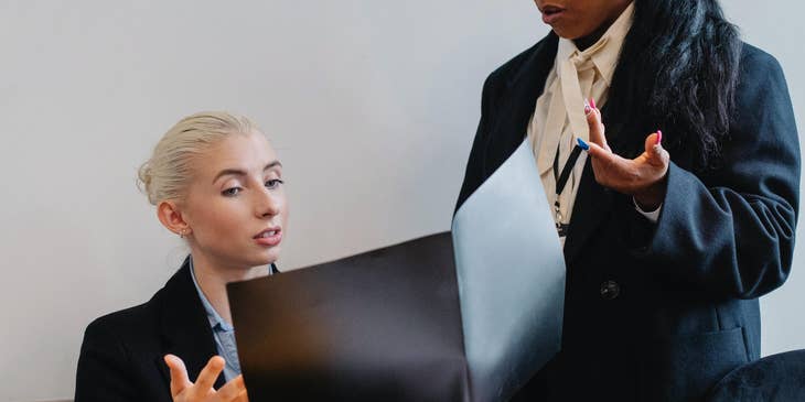 female Corporate Accountant discussing the details of the recent financial report with her colleague