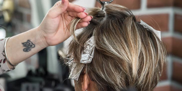 Cosmetologist coloring a client's hair