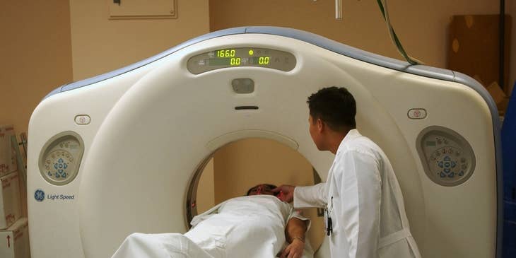 CT Technologist positioning the patient to scan specific areas of their bodies.
