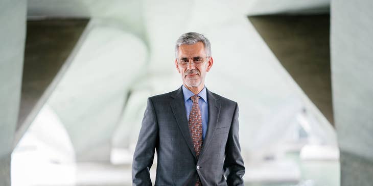 portrait of the Director of Finance in a business suit wearing eyeglasses