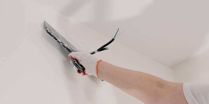 Drywall Finisher repairs imperfections to create a flat surface.