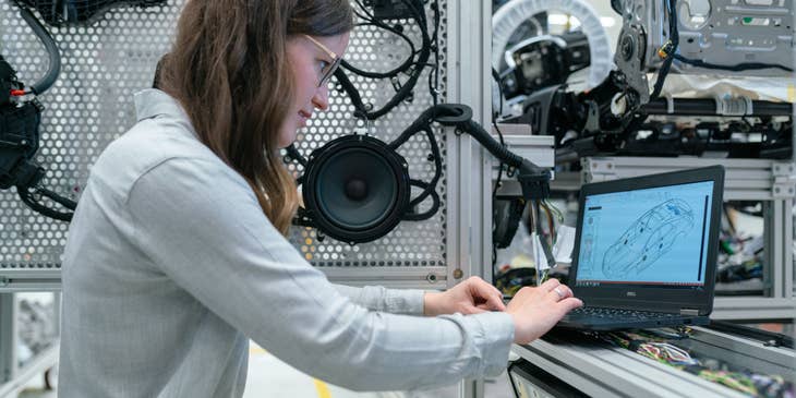 Electronics engineer running vehicle simulation tests on her laptop