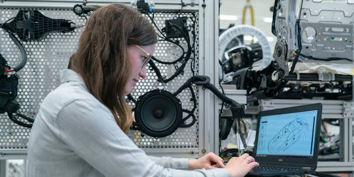 Electronics Engineer running vehicle simulation tests on her laptop